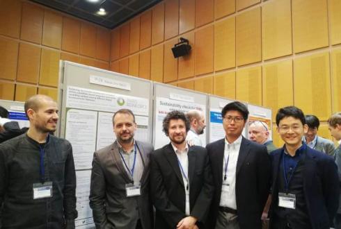 Alexandros Nikas and Haris Doukas discussing the PARIS REINFORCE poster with fellow researchers